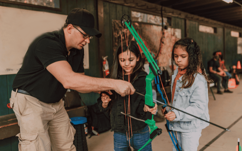 Children and teenagers practicing archery in a safe and playful environment