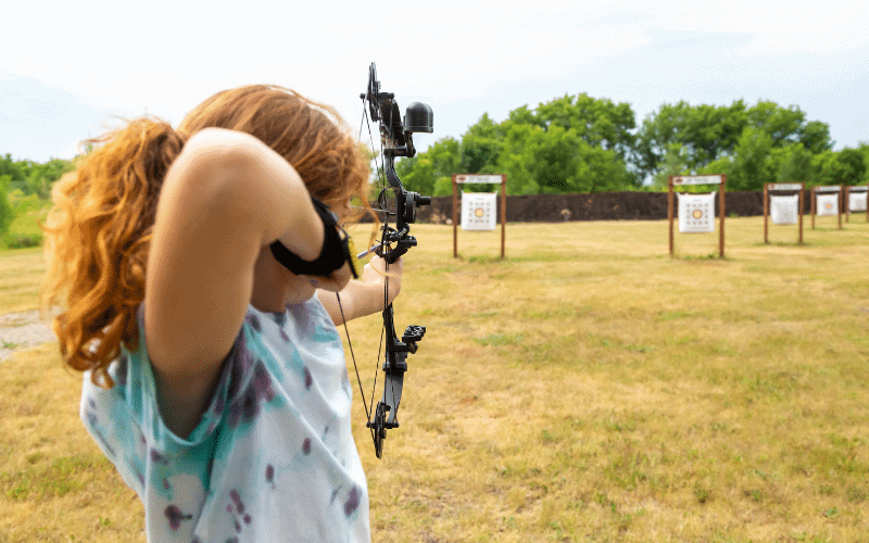 A modern archery range with historical and modern equipment, showcasing the evolution and institutionalization of the sport